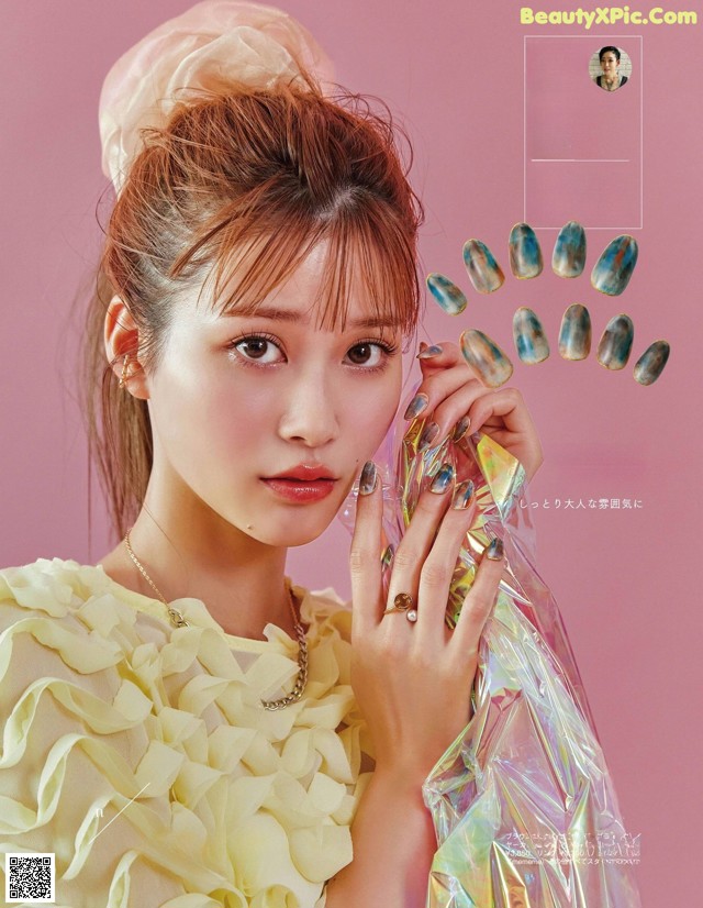 A woman in a yellow dress holding a bunch of nails.