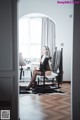 A woman sitting in a rocking chair in a room.